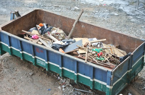 Builders' waste and construction debris being loaded for collection