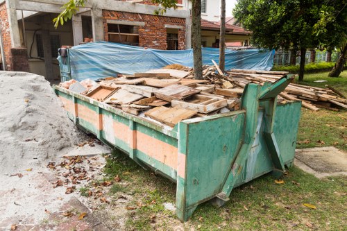 Workers sorting construction debris for recycling in West Ham